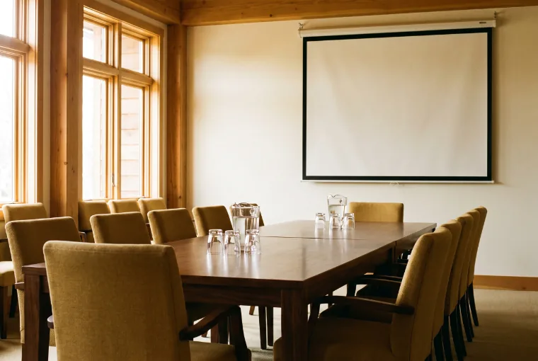An empty council meeting room in a cedar-clad building